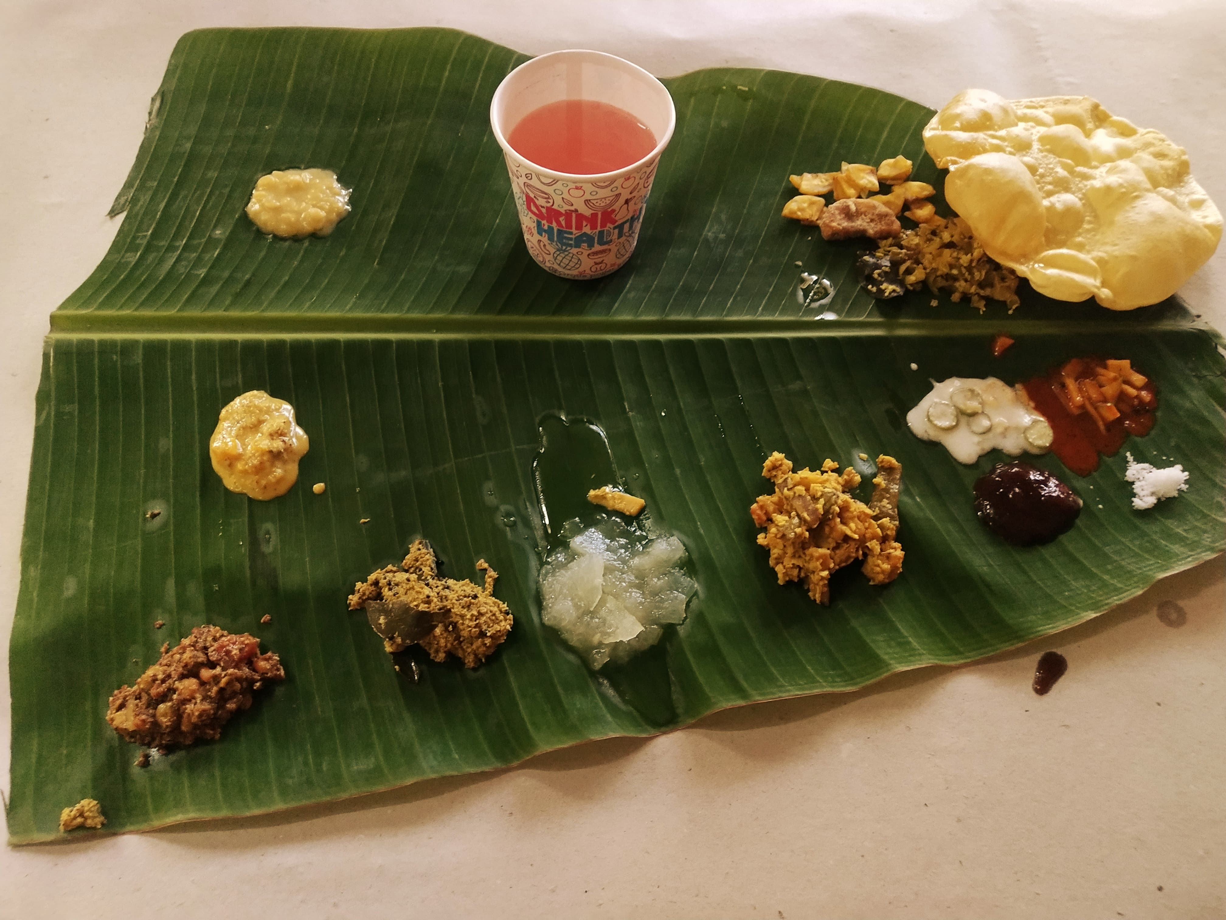 Close-up of served sadhya items on a banana leaf